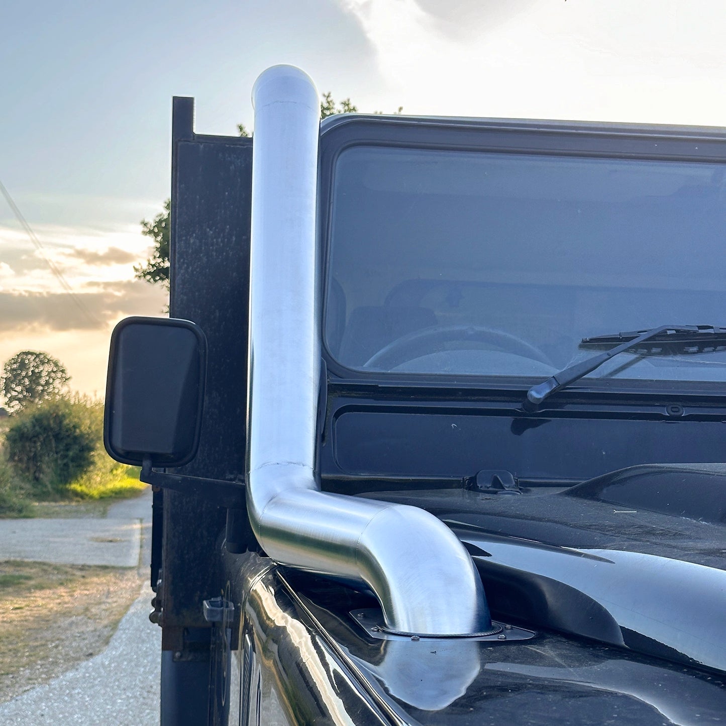 Close up front view of Landrover Defender with stainless steel Snorkle Kit installed