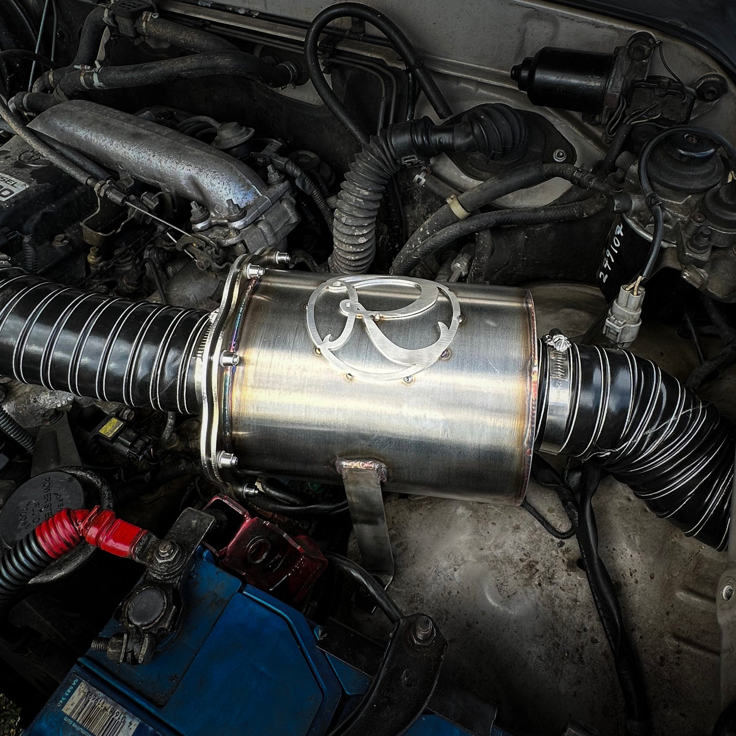 Close-up of a car engine with a Stainless steel airbox filter housing for off road vehicles